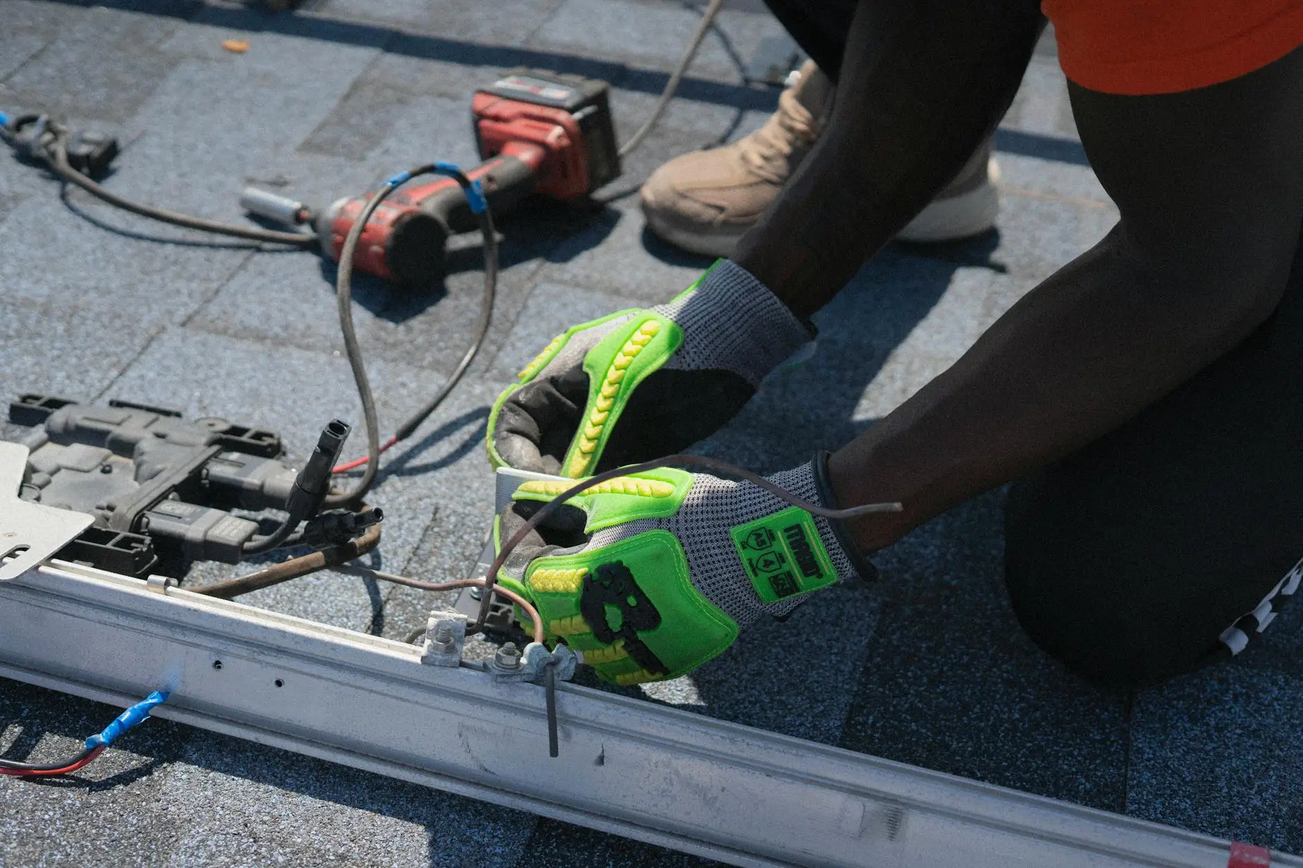A roofing crew carefully installing ice and water shield membrane on a steep roof deck in Summit, Utah