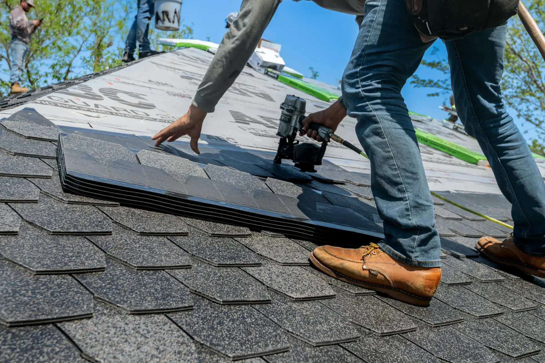 A roofing crew installing high-wind resistant asphalt shingles on a home in New Harmony, Utah.