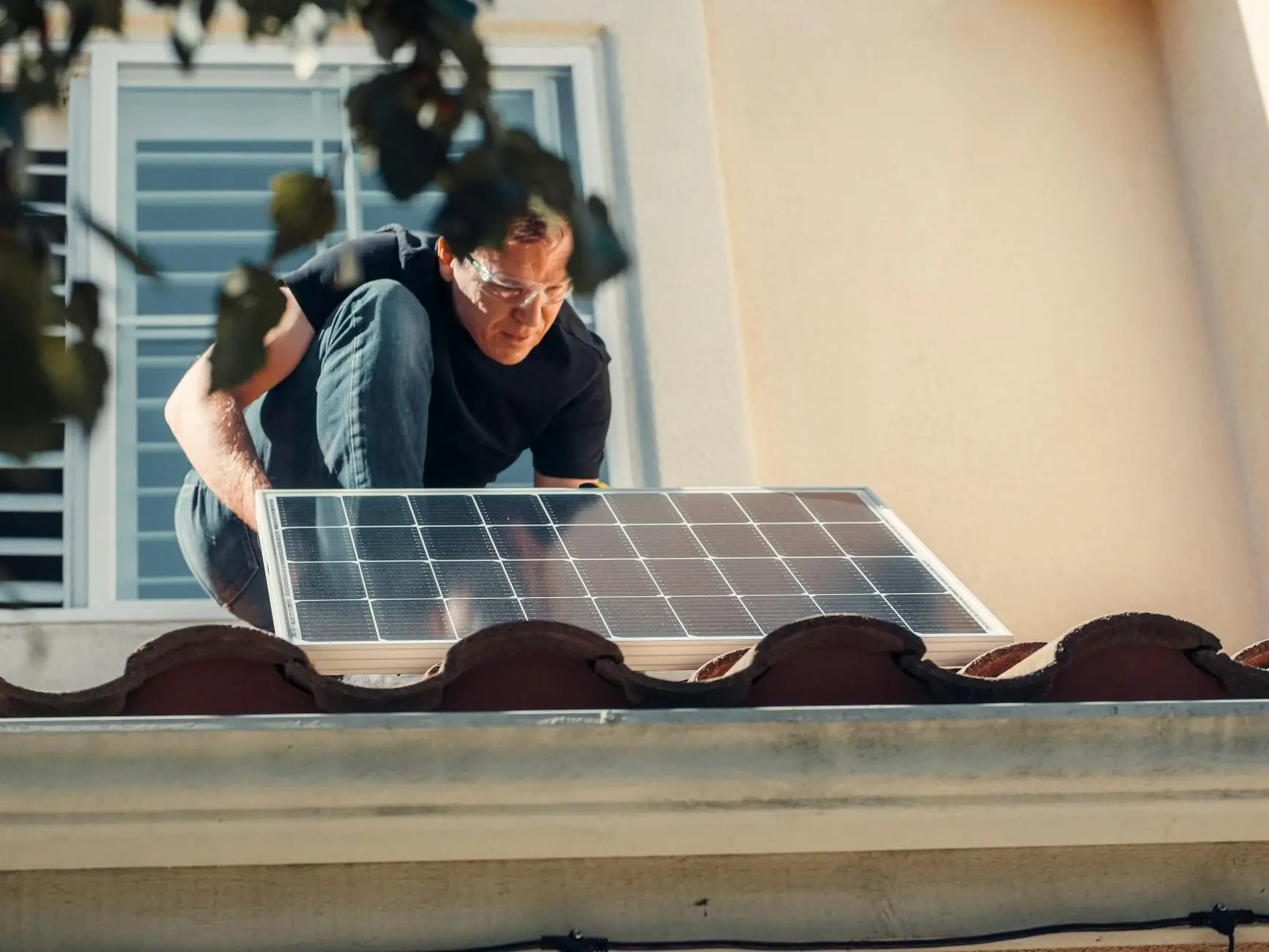 A professional roofing crew carefully installing high-wind rated shingles on a ranch-style home in Newcastle, Utah.