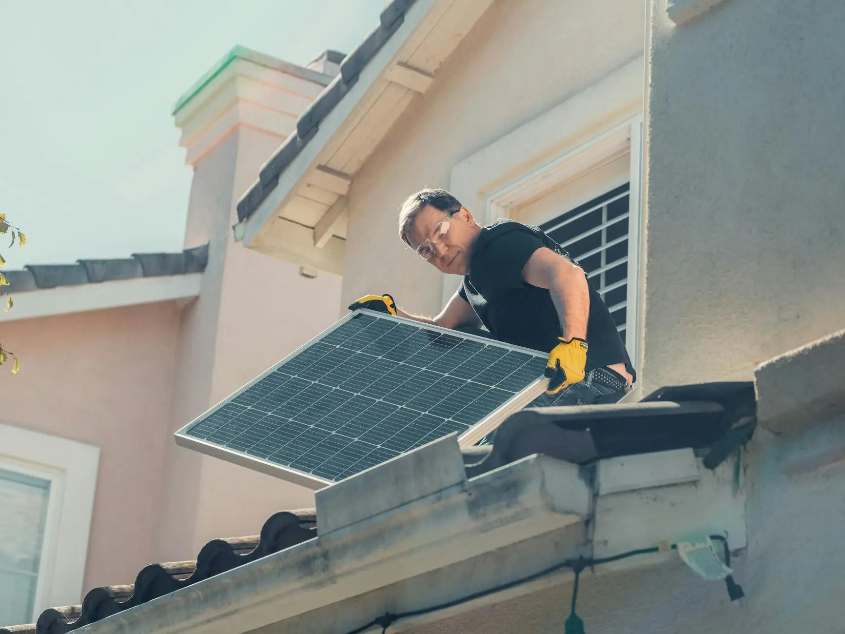 A professional roofer inspects a flashing installation on a clean, modern residential roof in Toquerville.